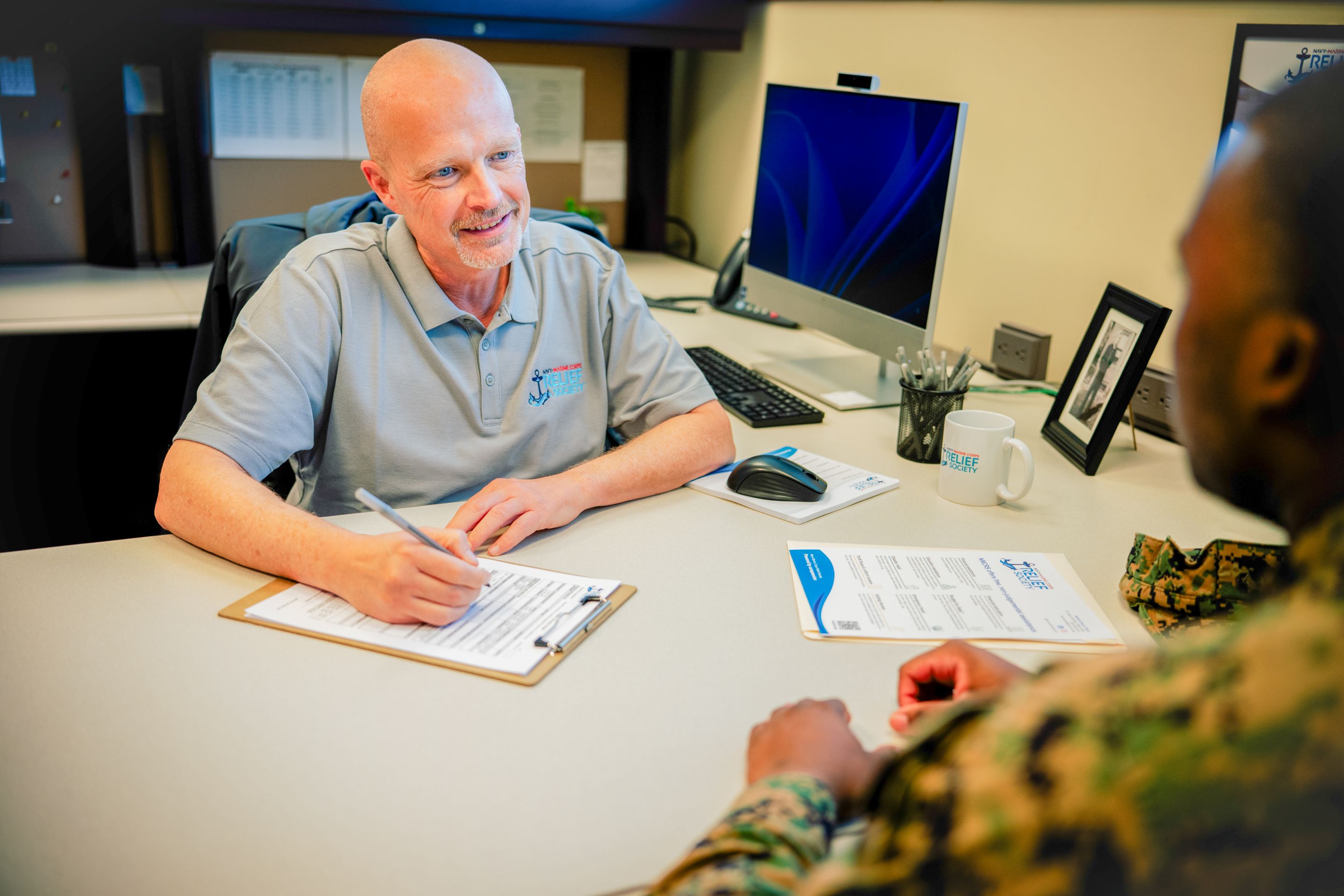 NMCRS caseworker meets with a service member
