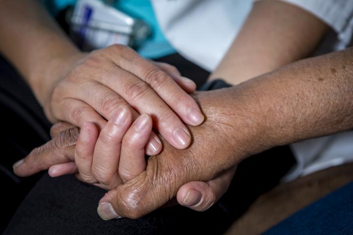 Holding hands with an elderly person