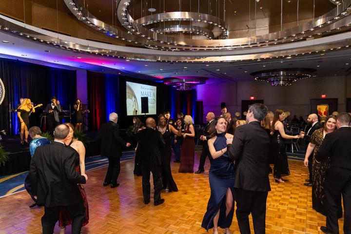 A crowd enjoys the dance floor at the 2025 NMCRS Ball 