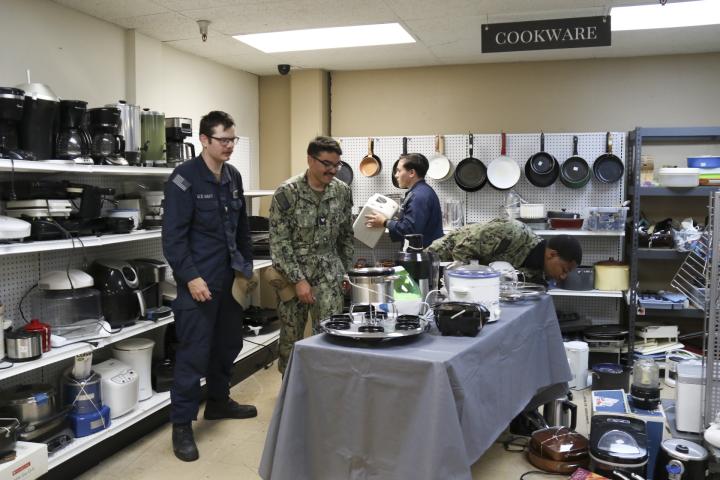 Sailors shopping for cookware in a thrift shop 