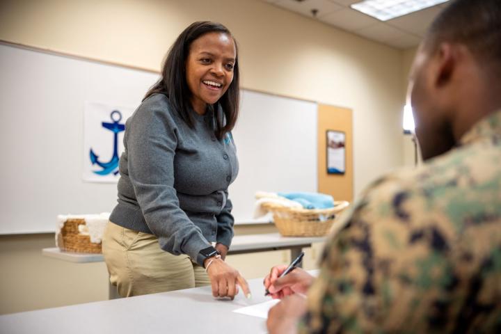 NMCRS volunteer teaching a service member