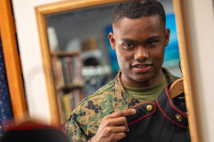 Service member inspecting his uniform at NMCRS