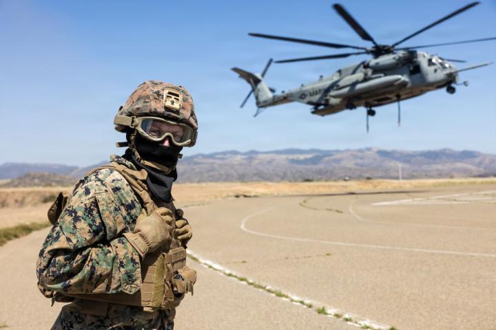 Solider on helicopter pad in mask and helmet