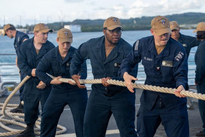 Sailors working together as a team, hauling a line