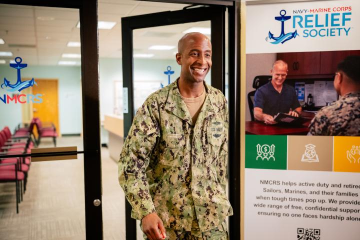 Sailor leaving an NMCRS office looking relieved