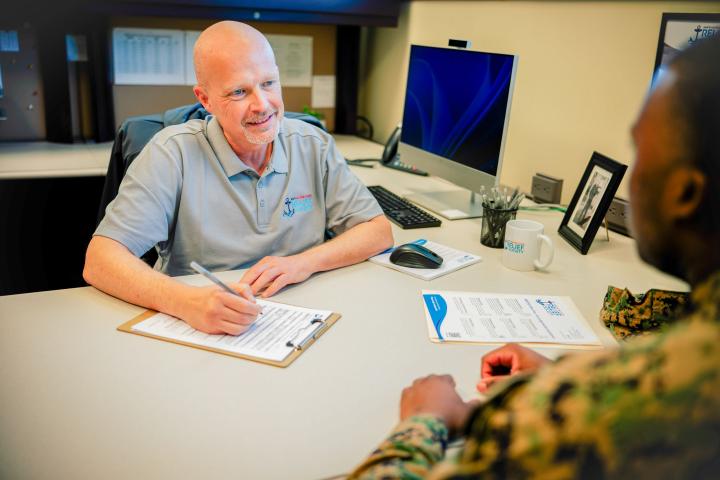NMCRS caseworker meets with a service member