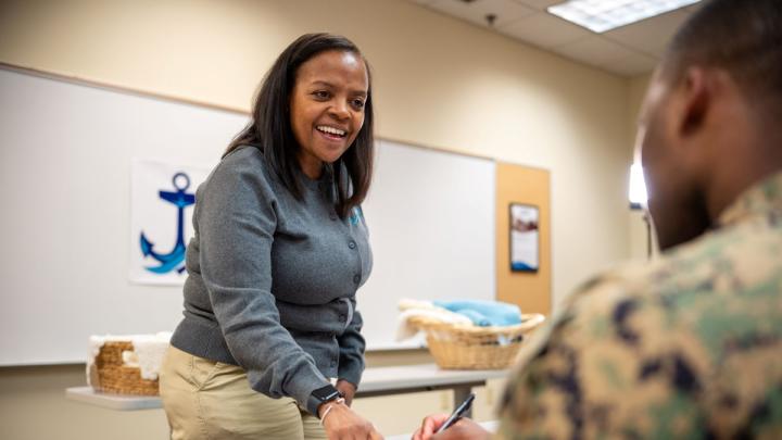 NMCRS volunteer teaching a service member