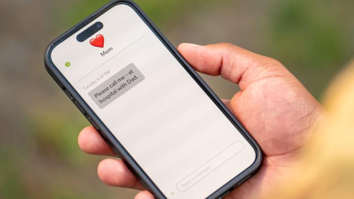 reading text message from mom. Dad is in hospital