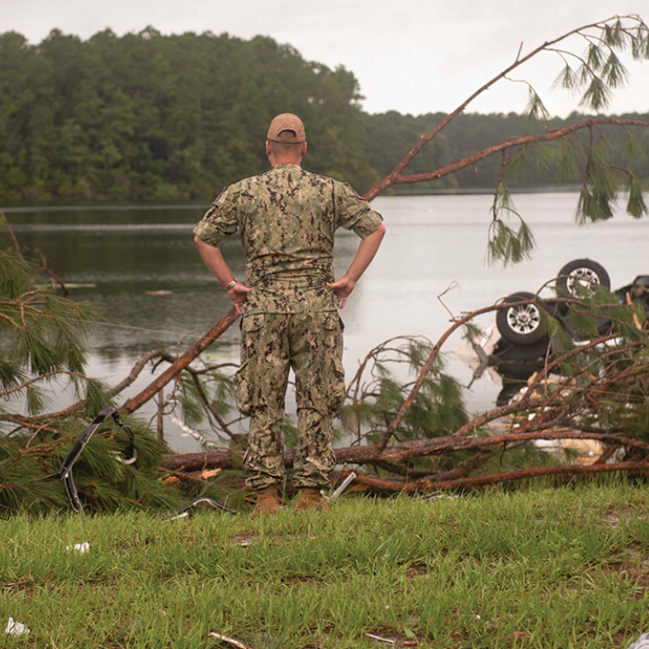 Man in uniform looks at lightning damage
