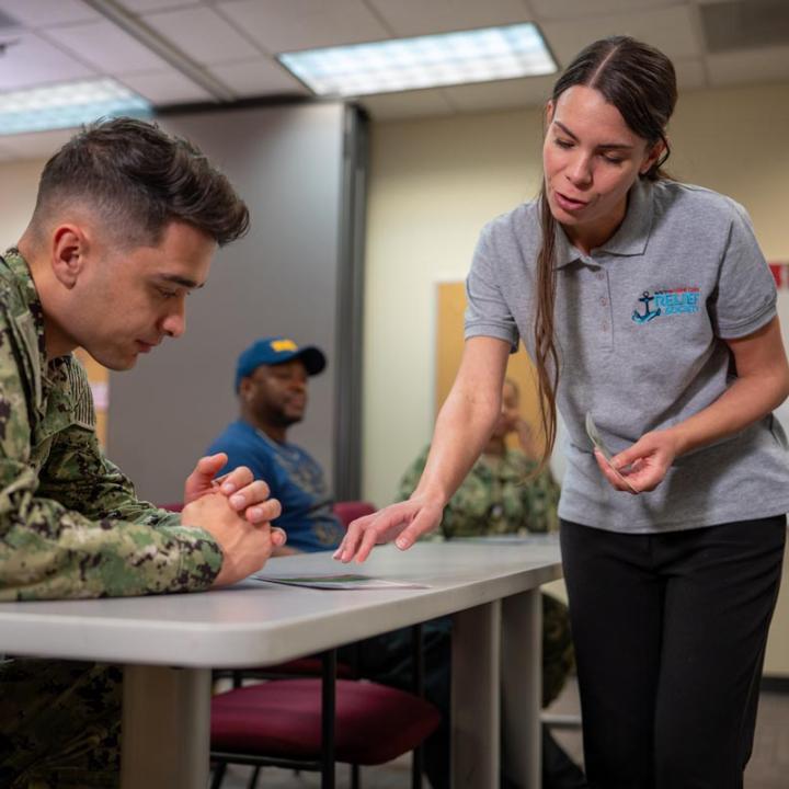 NMCRS volunteer helping a service member