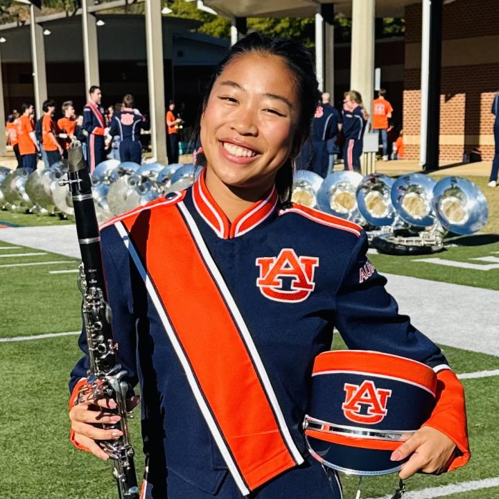 Female recipient of NMCRS education assistance wearing UA band uniform 