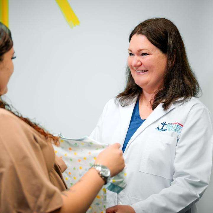 NMCRS Visiting Nurse talking with a patient