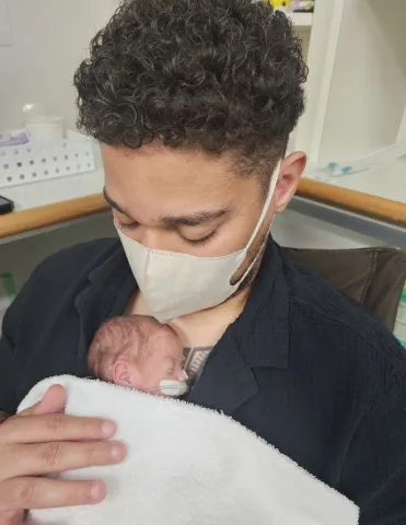 Sailor with baby in the NICU