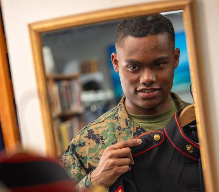 Service member inspecting his uniform at NMCRS