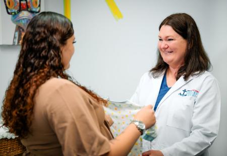 NMCRS Visiting Nurse talking with a patient